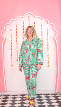 Load image into Gallery viewer, Person wearing a green pajama set with red cherries on a pink background